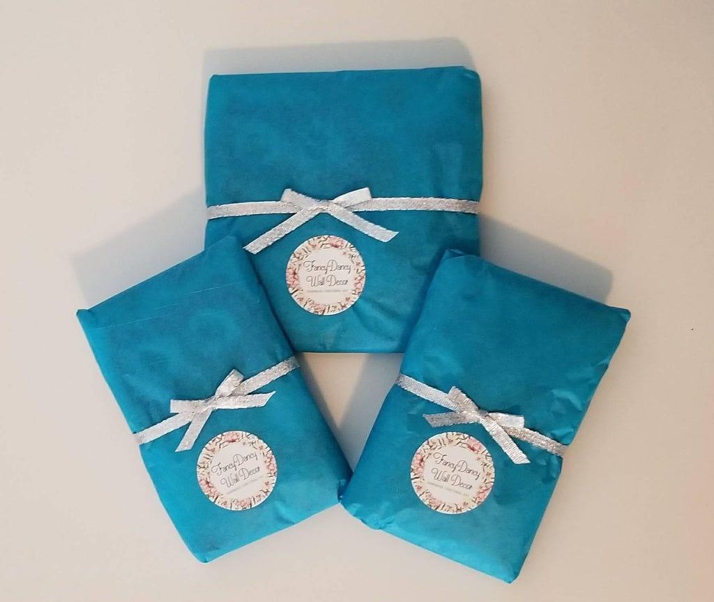 Gift wrapping in blue tissue with silver ribbon